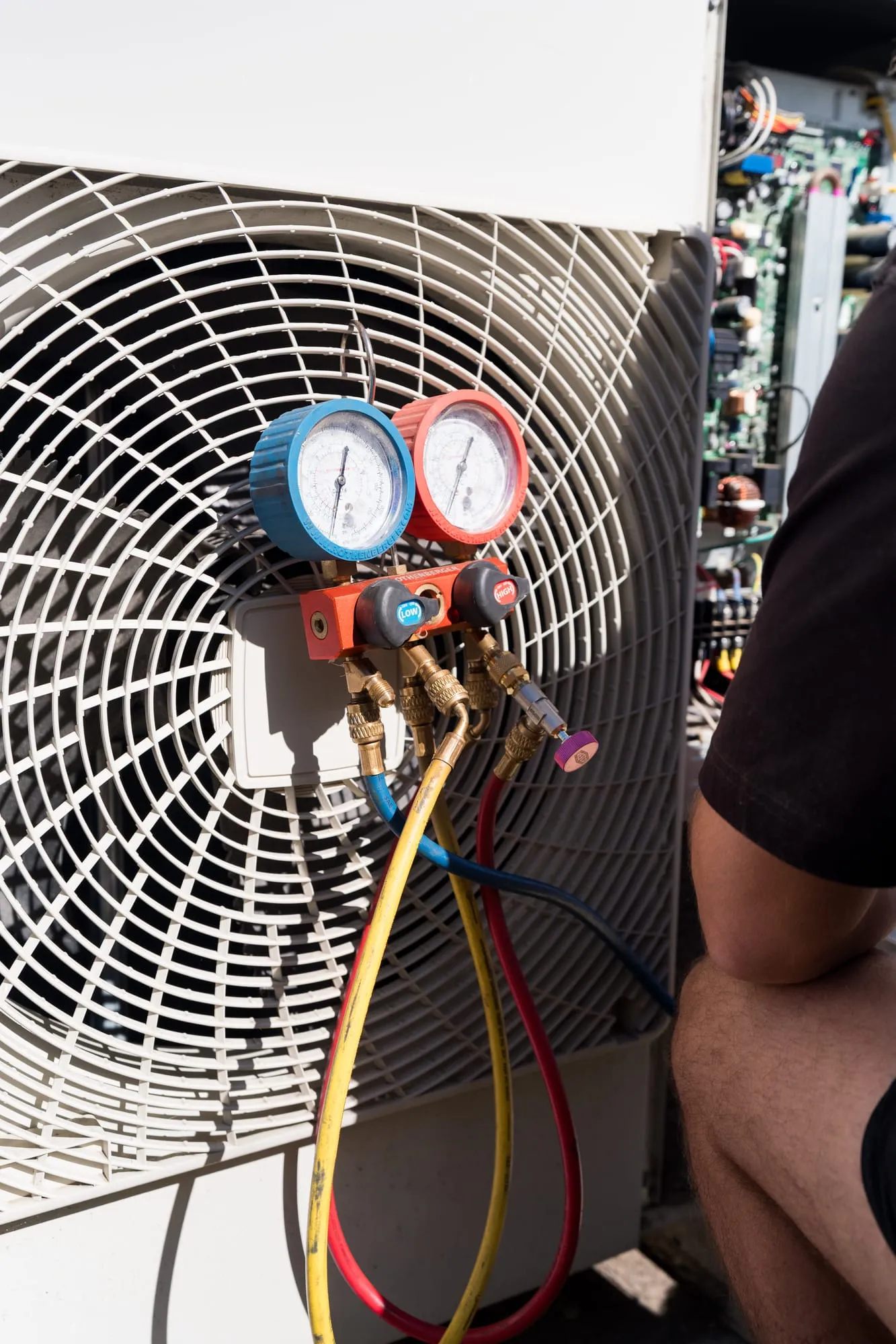 Close-up of refrigerant pressure gauges on an air conditioner