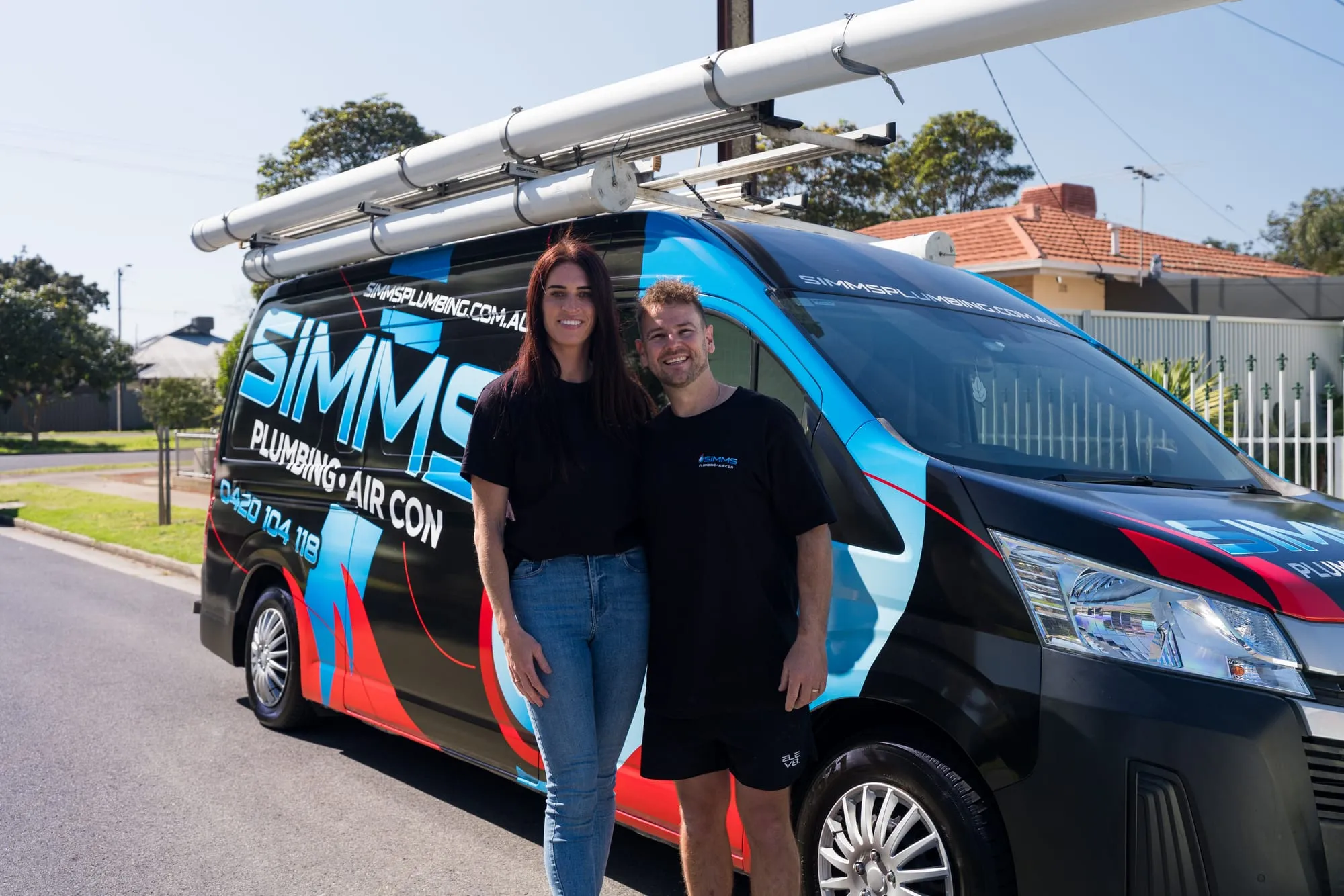Simms plumber with a family member beside the van