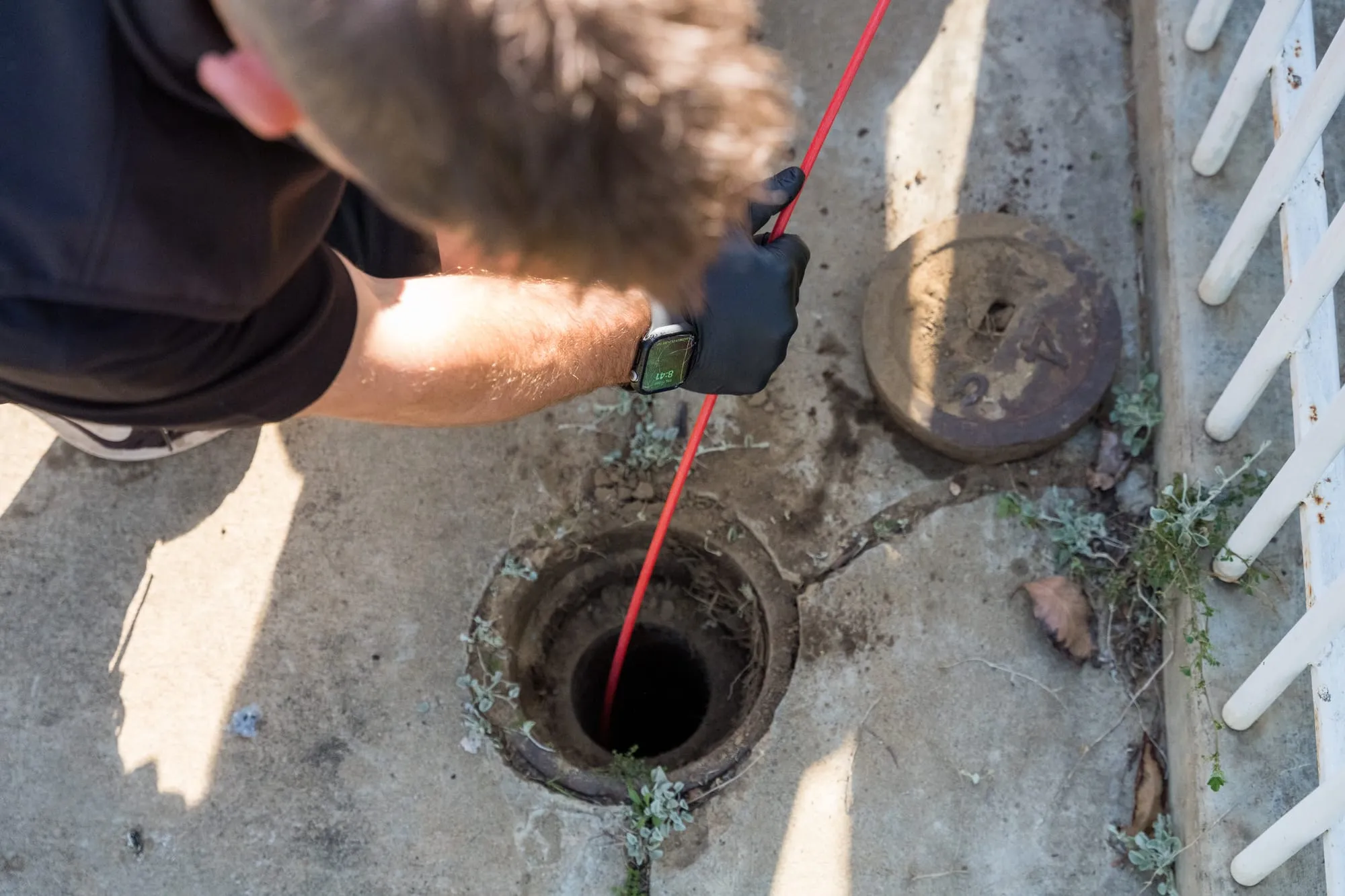 CCTV drain camera being fed into a drain opening