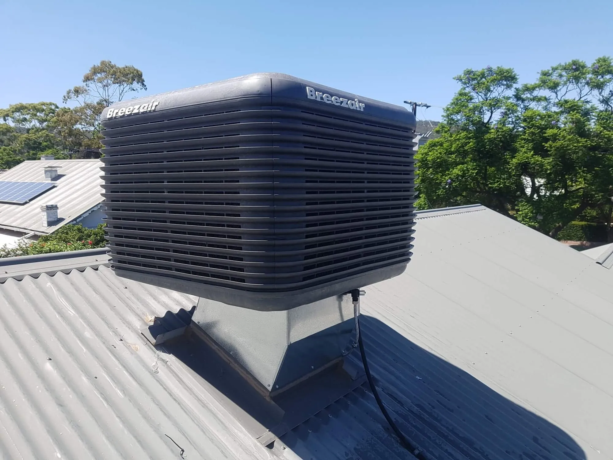 Rooftop evaporative cooler on a southern Adelaide home
