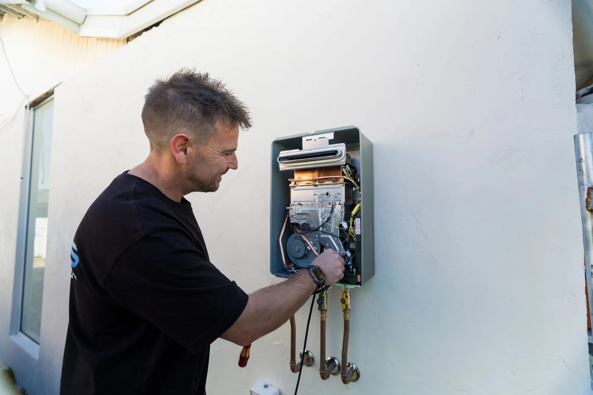 Gas hot water unit opened up for service