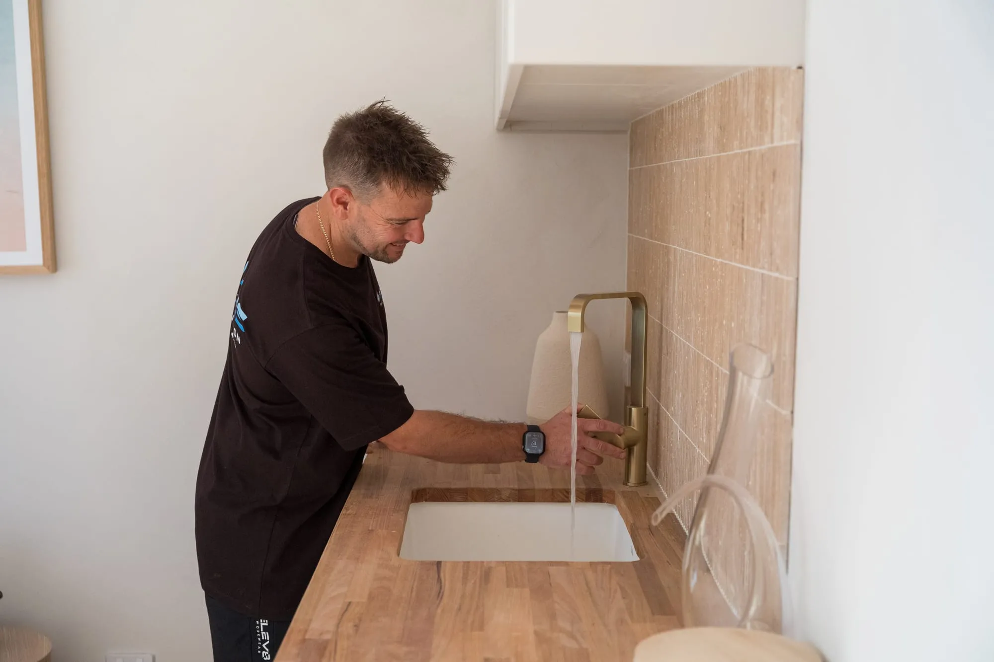Simms plumber checking a kitchen tap