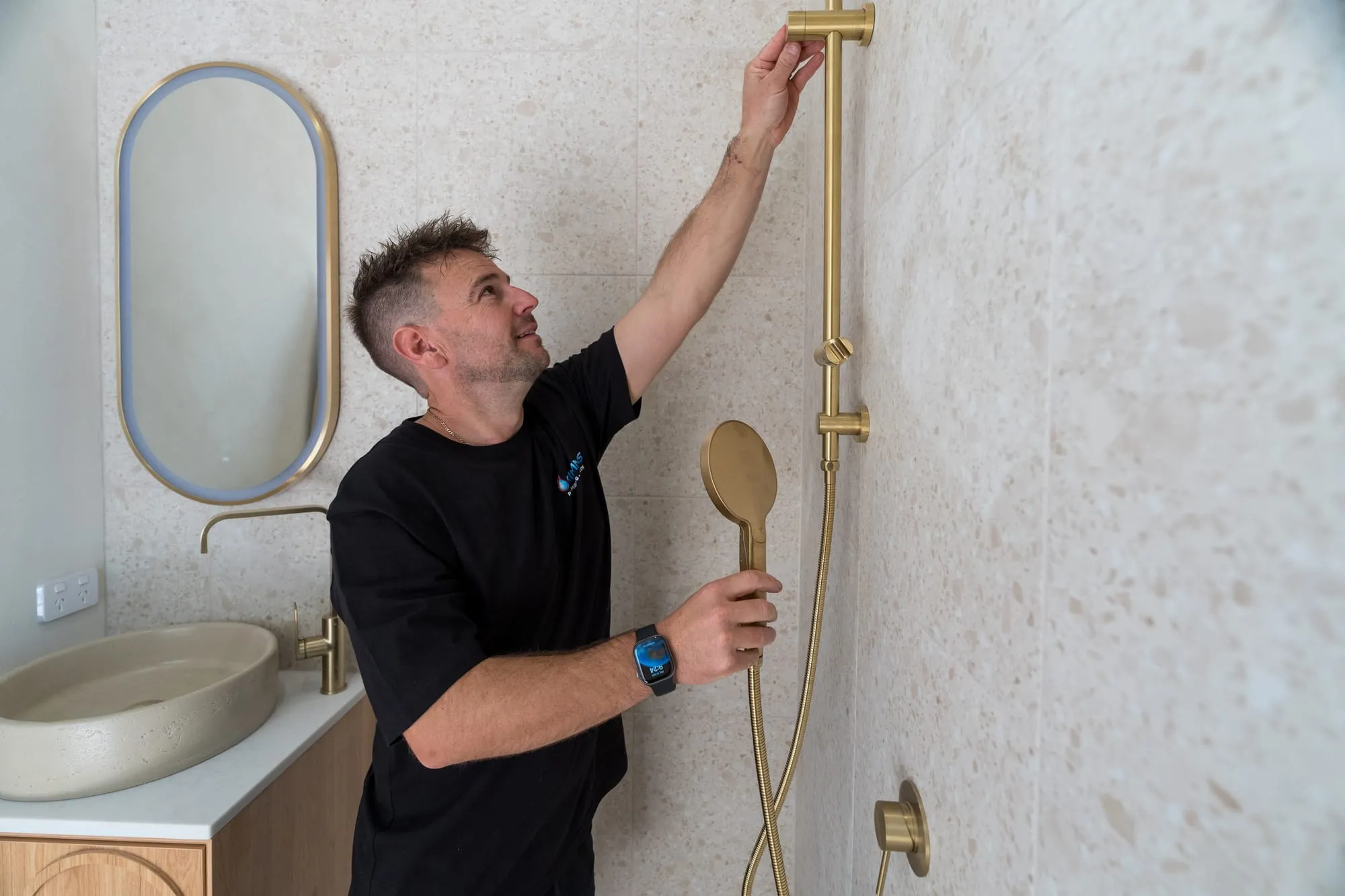 Simms plumber fitting a shower rail and mixer