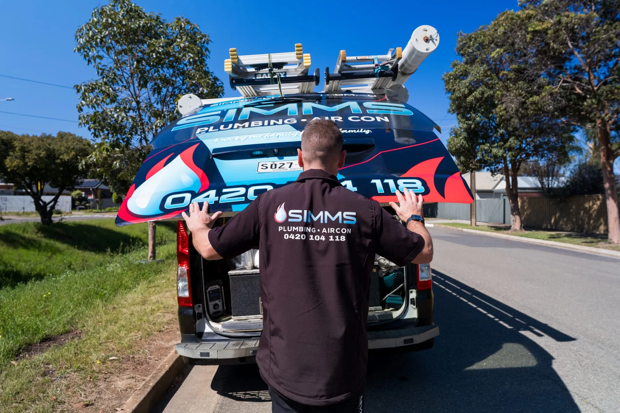 Simms plumber at the rear of the van getting equipment ready